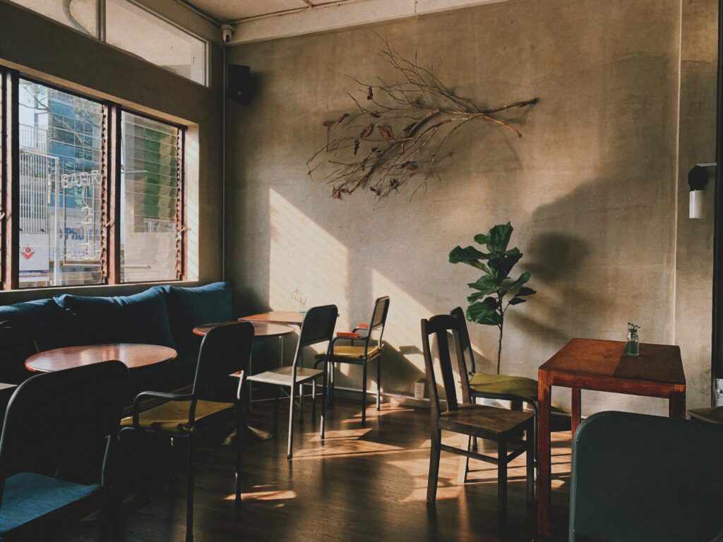 empty cafe interior with natural light streaming through windows