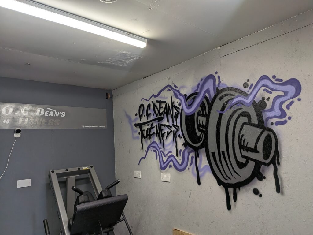 Leg press and branded wall art at O.C. Dean’s Fitness, Margate