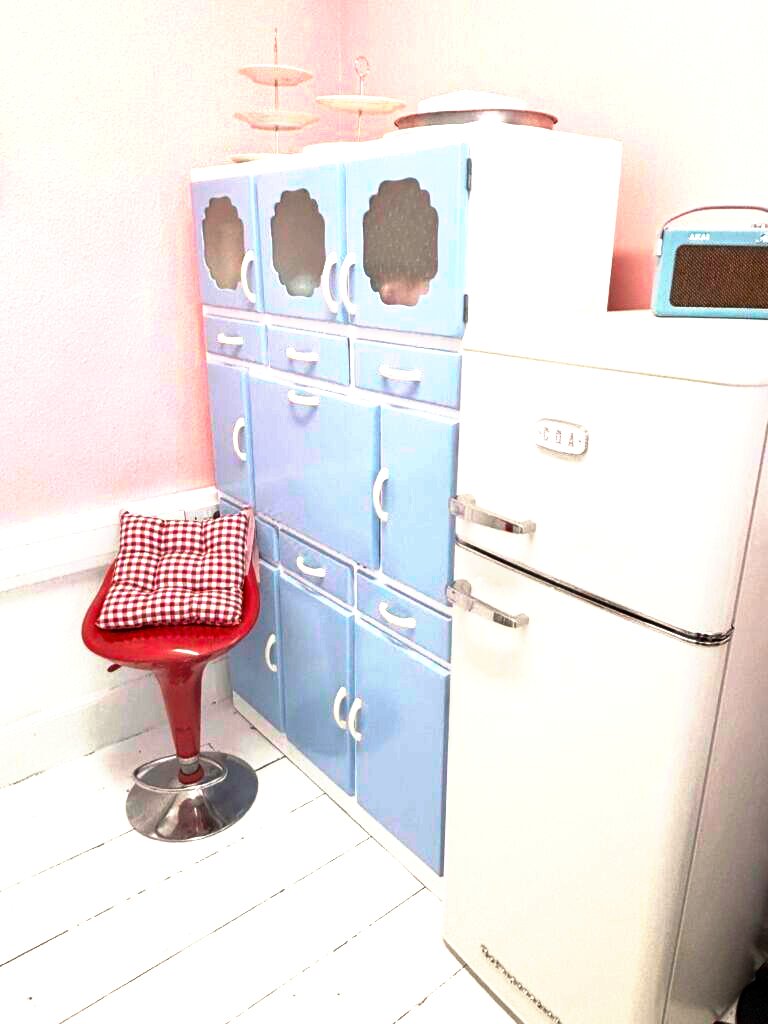 Pastel vintage kitchenette with baby blue larder cabinet and retro fridge at Le Keux Vintage, Margate