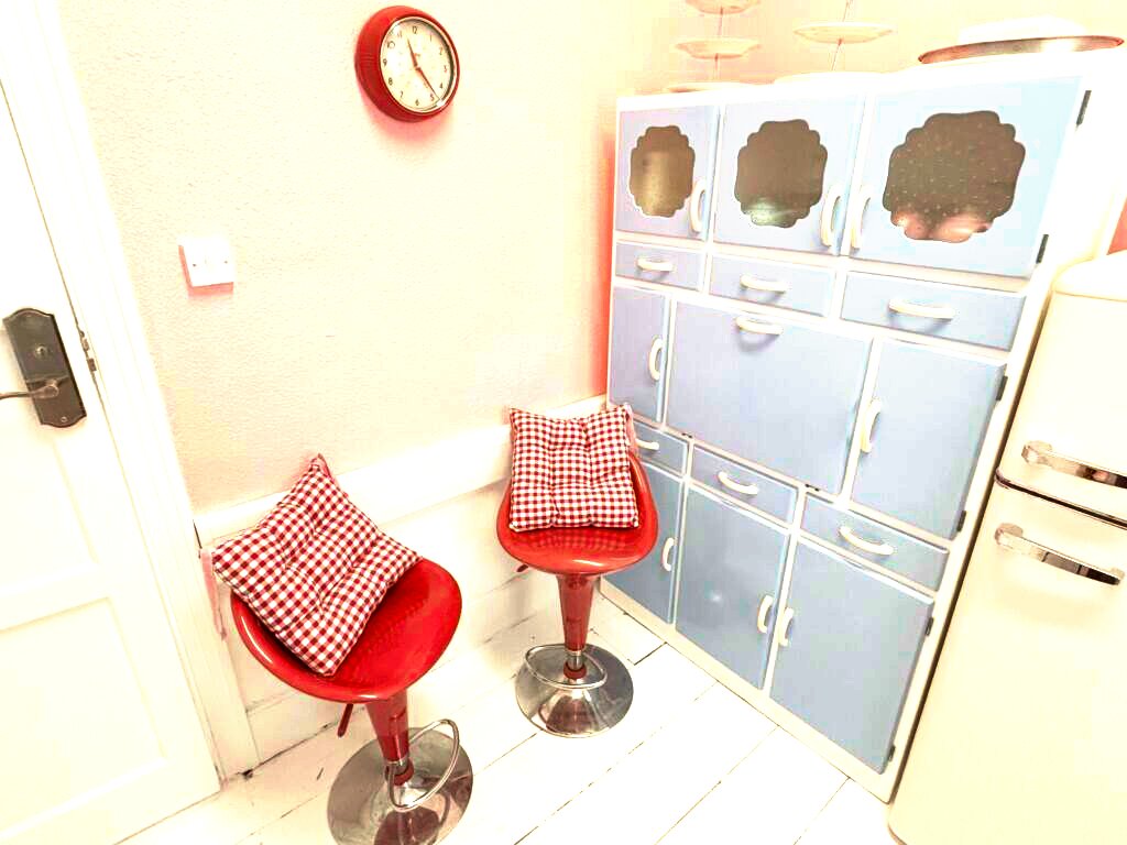 Vintage kitchen set with red bar stools and wall clock at Le Keux Vintage, Margate