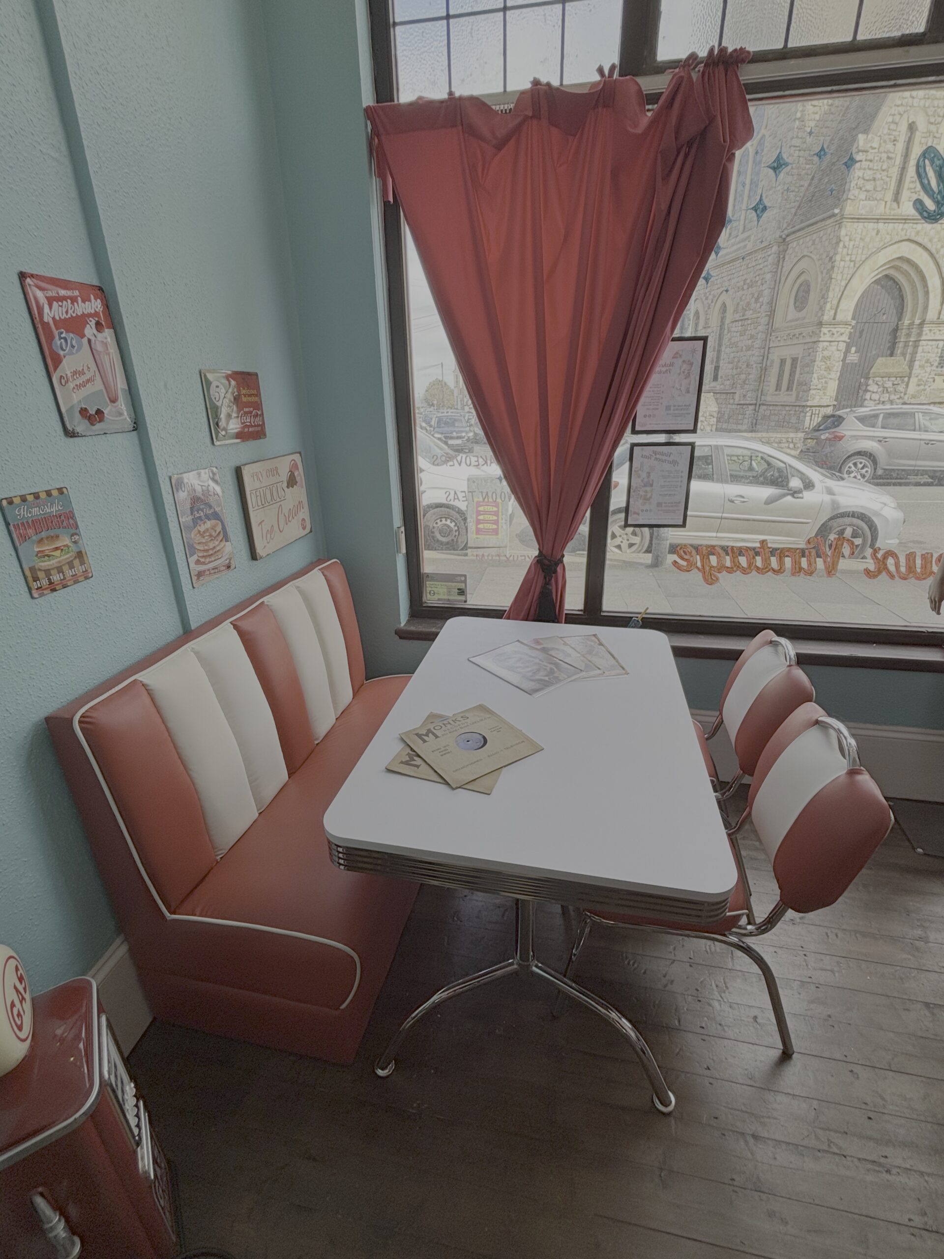 1950s American diner booth with red vinyl seating and vintage signs at Le Keux Vintage, Margate