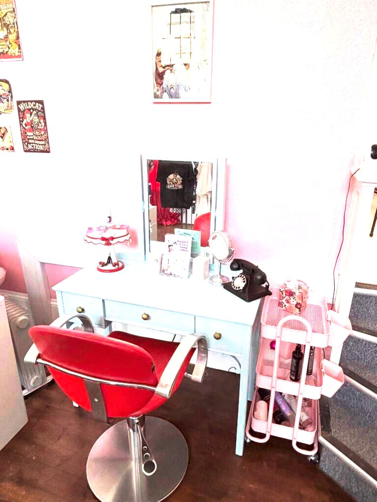 Vintage dressing table setup with rotary phone, red salon chair and pink trolley at Le Keux Vintage, Margate