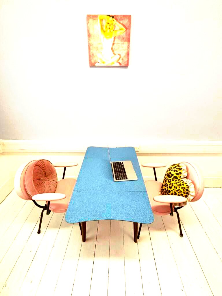Private retro meeting room with blue table, pink chairs and vintage artwork at Le Keux Vintage, Margate
