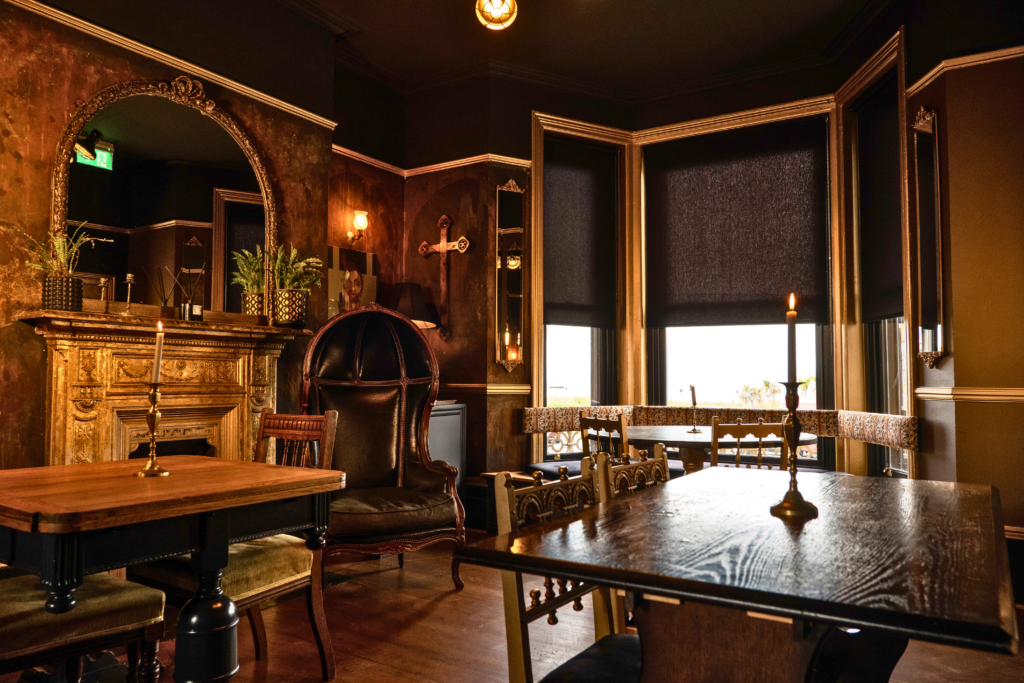 Gothic bar lounge with ornate fireplace, gilt mirror, and candlelight at The Albion Rooms, Margate
