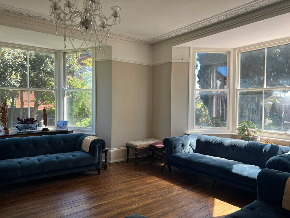 Bright living room with large windows in Victorian villa Margate