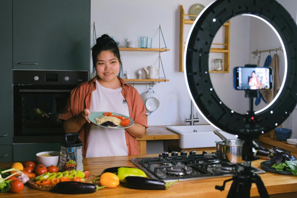 UGC content creator filming in a residential kitchen with wooden worktops and open shelving in Kent
