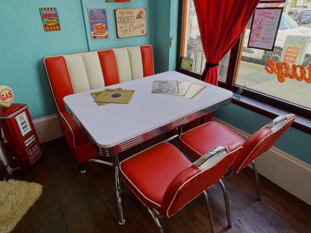 Retro 1950s American diner booth with red and white striped seating and chrome table at Le Keux, a vintage photoshoot location in Thanet