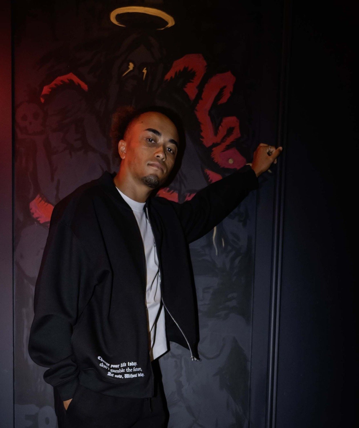 Champagne Poker model posing against a painted mural wall during a brand shoot at The Albion Rooms, Margate