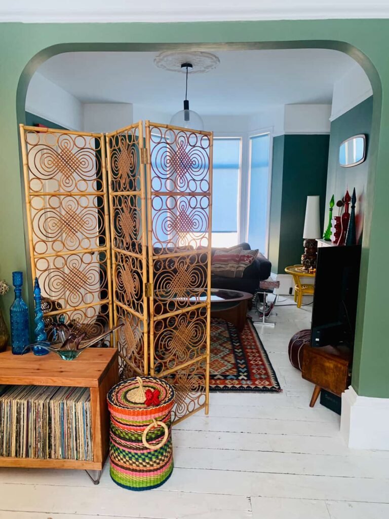 Vintage rattan screen in the archway at The Peacock House Margate with kilim rug and vinyl record collection
