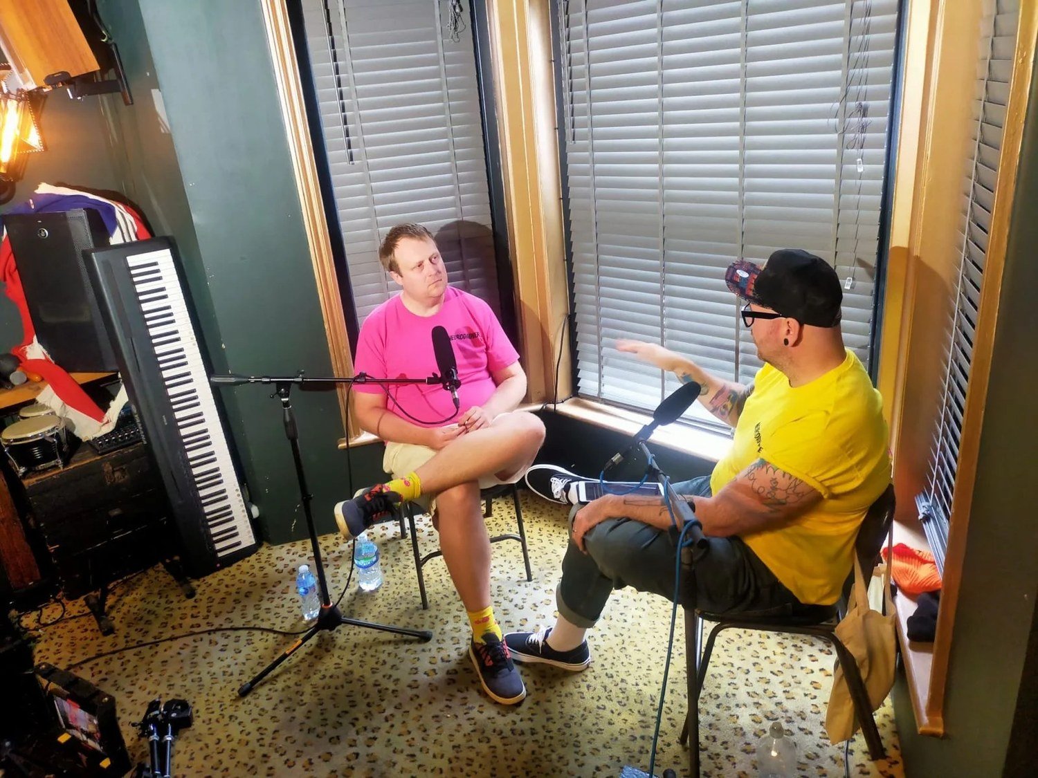 Wide view of the video podcast setup showing seating, microphone stands and smartphone camera rigs inside The Albion Rooms bar