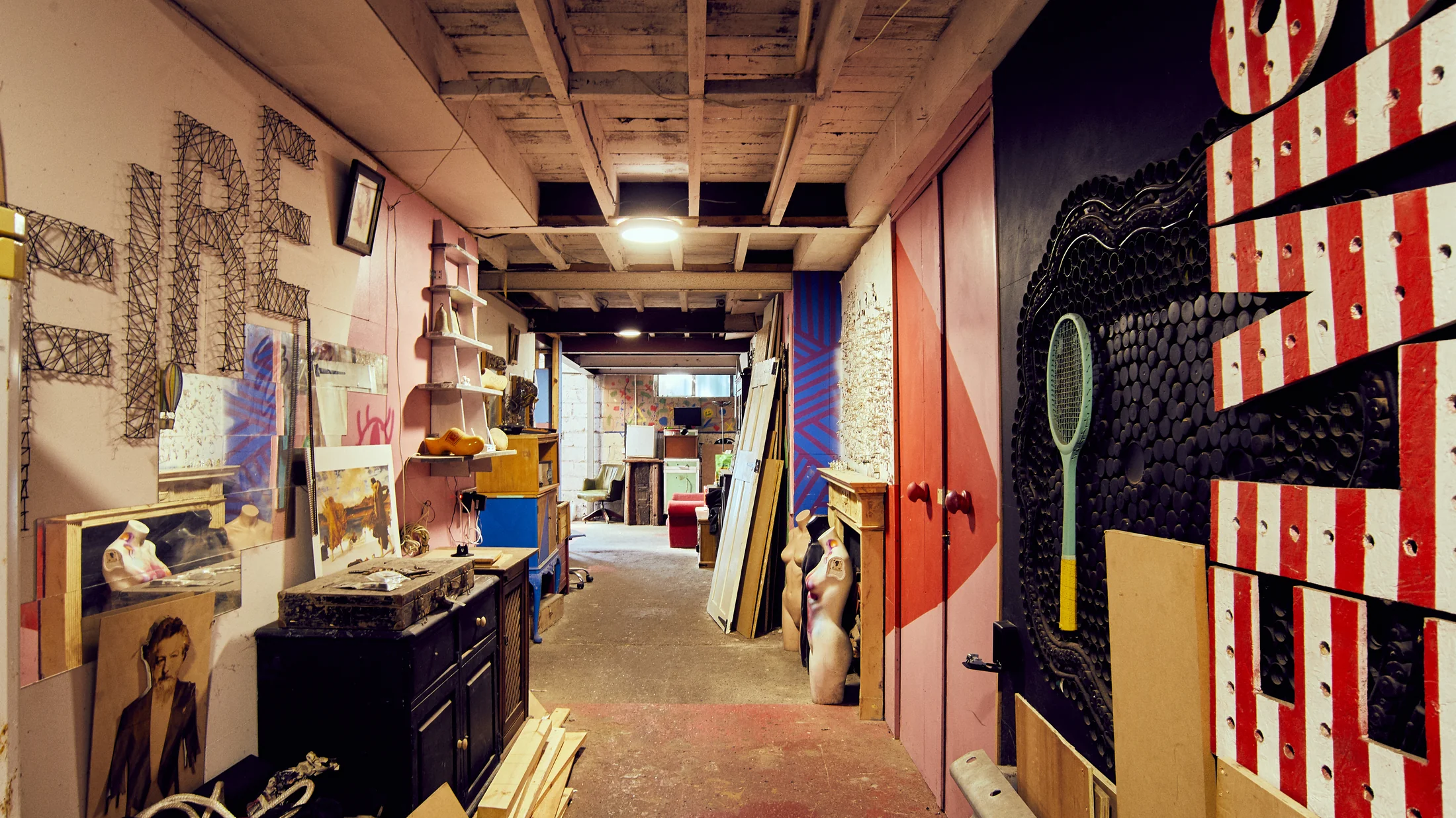 Creative corridor at Fire Eye Land with artwork, props and colourful textured surfaces