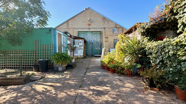 Garden courtyard leading to the rear studio building at Fire Eye Land